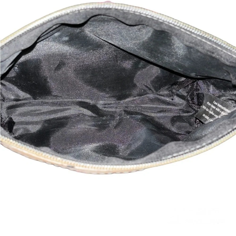 Ruby Cash animal print top zipper makeup bag. Black, tan and cream.